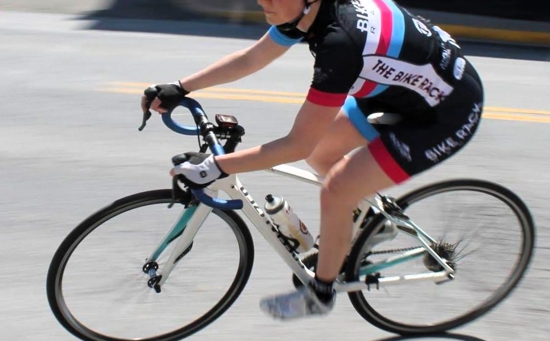 A woman racing a road bicycle.